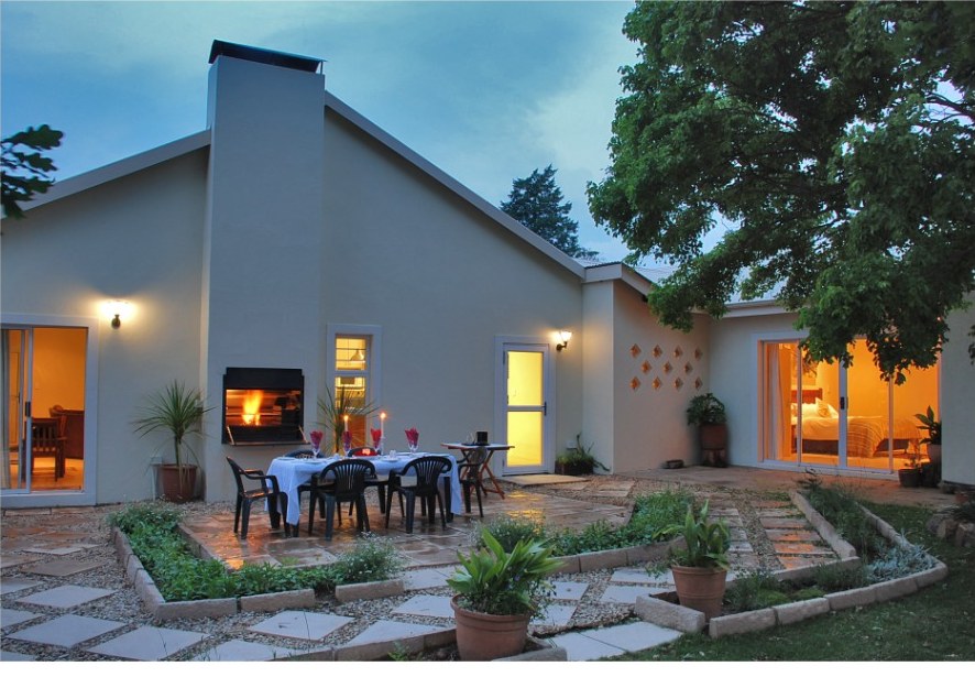 The Trout and Butterfly exterior at dusk, with the patio set for outdoor dining